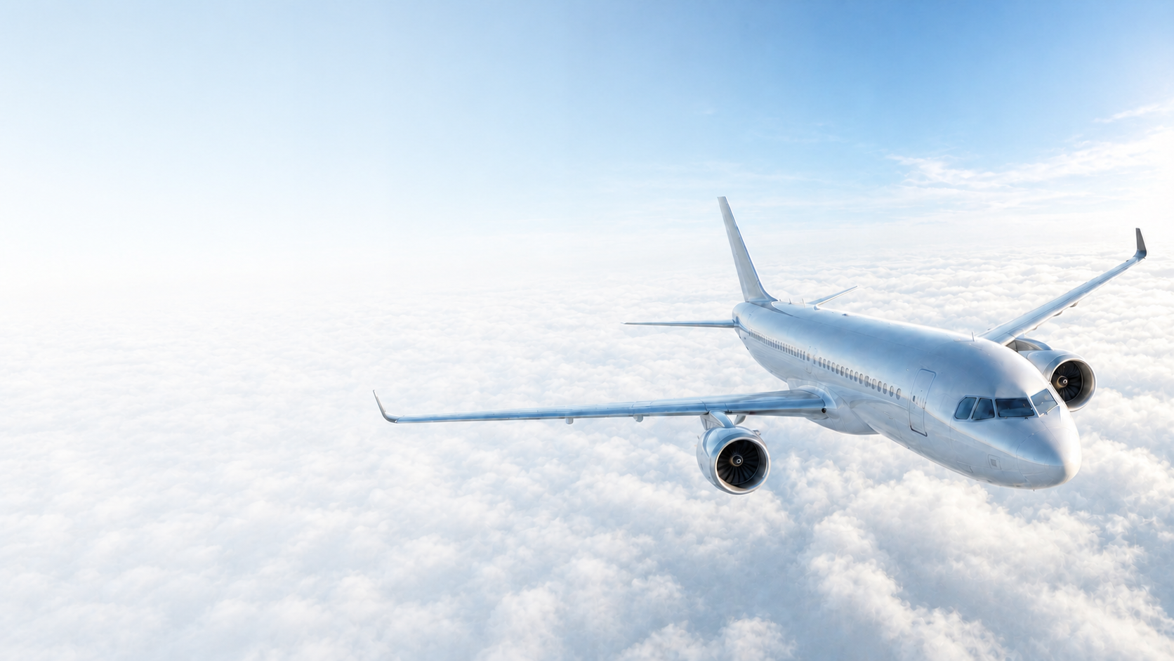 Commercial airplane flying above bright clouds
